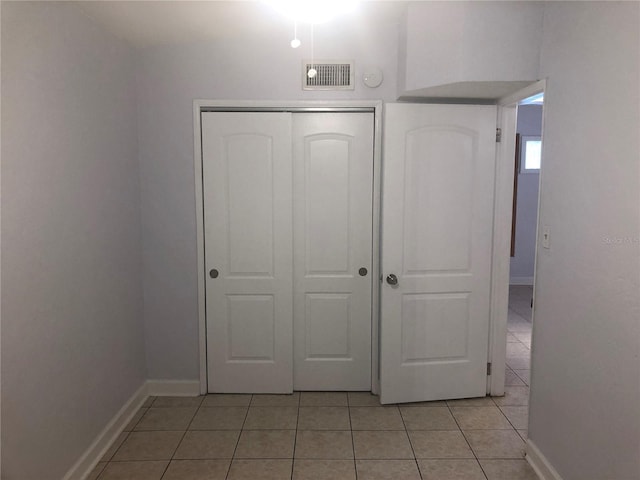 122 19th Ave N, Saint Petersburg, FL 33704 - unfurnished bedroom featuring visible vents, baseboards, light tile patterned floors, and a closet