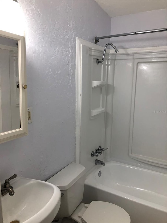 122 19th Ave N, Saint Petersburg, FL 33704 - full bath with toilet, a textured wall,  shower combination, and a sink