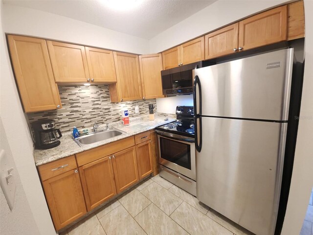 2210 Irene St, Lutz, FL 33549 - kitchen featuring stainless steel appliances, a sink, backsplash, and light tile patterned floors