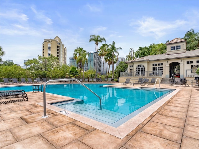 community pool featuring a patio and fence