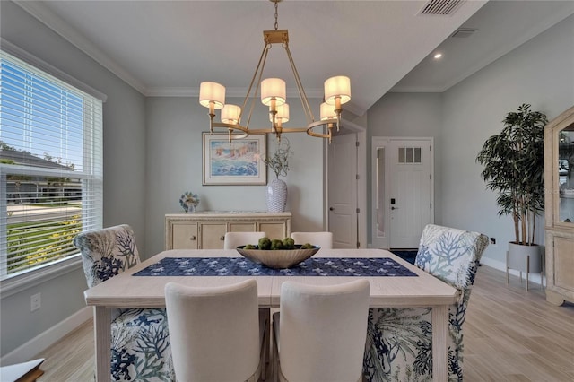 5828 Clairwood Ct, Palmetto, FL 34221 - dining room featuring a chandelier, plenty of natural light, baseboards, light wood finished floors, and crown molding