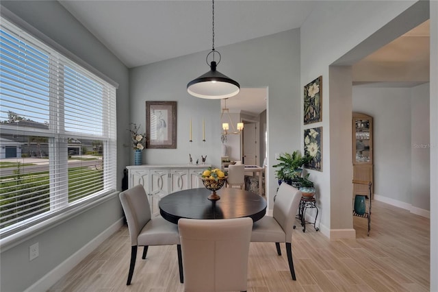 5828 Clairwood Ct, Palmetto, FL 34221 - dining space featuring plenty of natural light, baseboards, light wood-type flooring, and vaulted ceiling