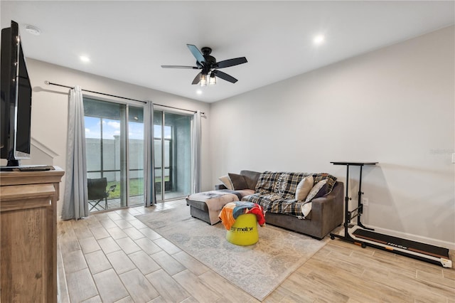 living area with a ceiling fan, recessed lighting, and wood finished floors