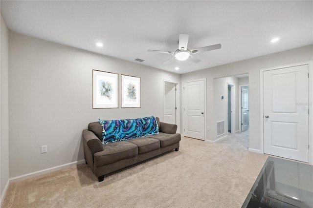 living area featuring light colored carpet, baseboards, and visible vents