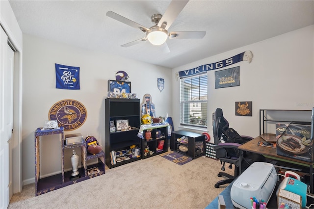 carpeted home office with ceiling fan