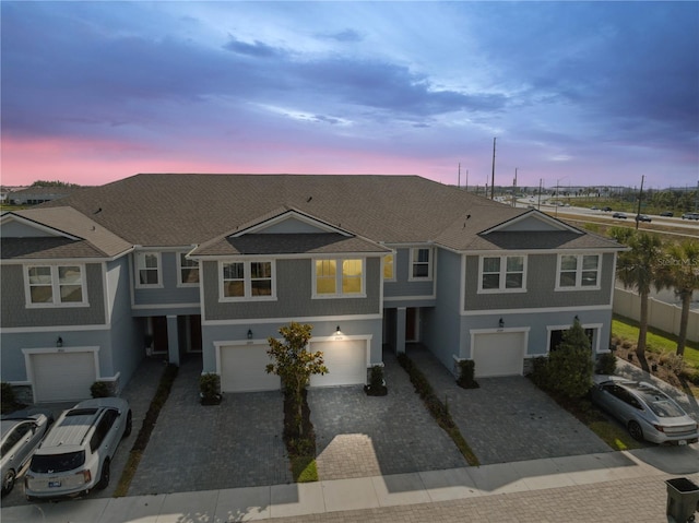 view of front of house featuring a garage, stucco siding, and driveway