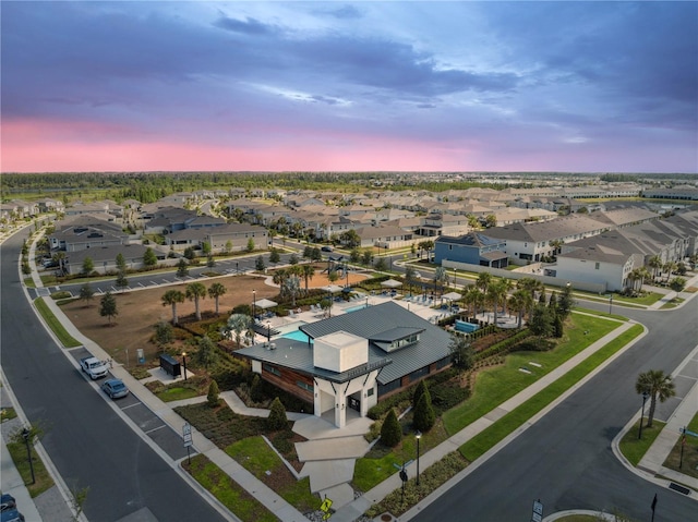 aerial view at dusk featuring a residential view