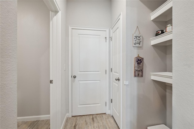 interior space with baseboards and light wood-style floors