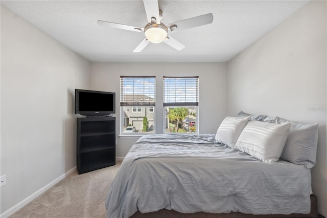 bedroom with baseboards, ceiling fan, and carpet floors