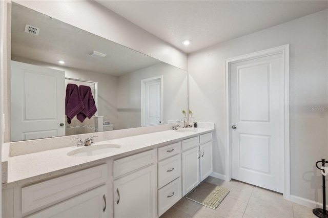 full bathroom with a sink, double vanity, visible vents, and tile patterned flooring