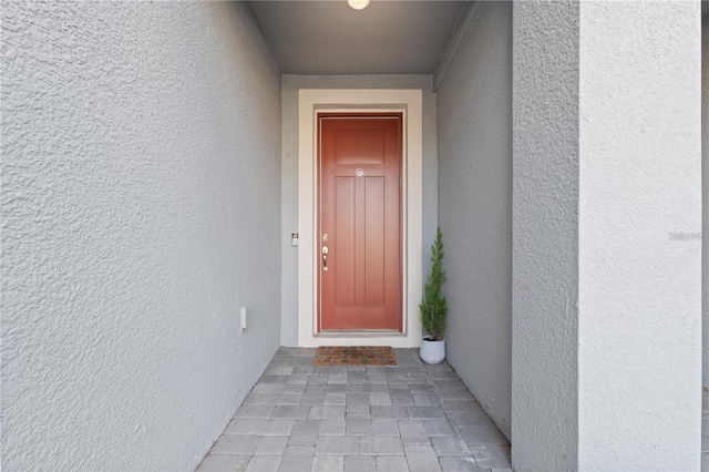 doorway to property with stucco siding