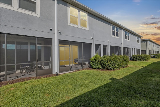 2529 Arbor Wind Dr, Lutz, FL 33558 - back of house at dusk with a lawn and stucco siding