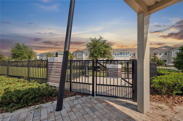 2529 Arbor Wind Dr, Lutz, FL 33558 - gate at dusk with fence and a residential view