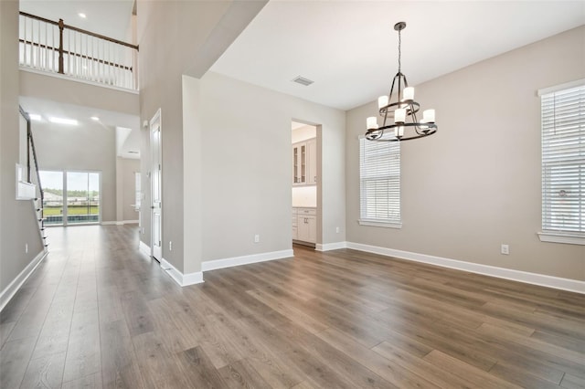 34084 Torrent Ln, Wesley Chapel, FL 33543 - spare room with a chandelier, dark wood finished floors, and baseboards