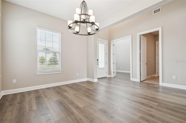 34084 Torrent Ln, Wesley Chapel, FL 33543 - spare room with a chandelier, wood finished floors, and baseboards