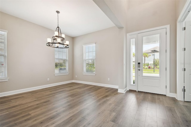 34084 Torrent Ln, Wesley Chapel, FL 33543 - entrance foyer with a chandelier, wood finished floors, and baseboards