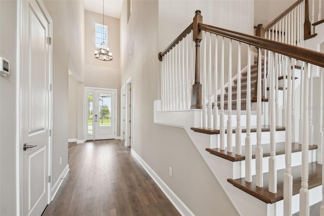 34084 Torrent Ln, Wesley Chapel, FL 33543 - foyer entrance with wood-type flooring, baseboards, stairs, a chandelier, and a towering ceiling