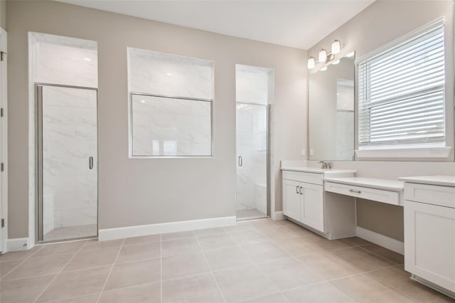 34084 Torrent Ln, Wesley Chapel, FL 33543 - full bathroom featuring a marble finish shower, vanity, tile patterned floors, and baseboards