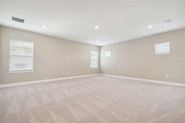 34084 Torrent Ln, Wesley Chapel, FL 33543 - empty room with light carpet, healthy amount of natural light, baseboards, and recessed lighting