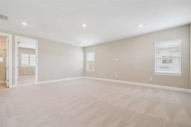 34084 Torrent Ln, Wesley Chapel, FL 33543 - empty room featuring light carpet, baseboards, and recessed lighting