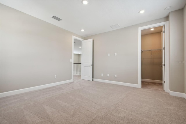 34084 Torrent Ln, Wesley Chapel, FL 33543 - unfurnished bedroom featuring a spacious closet, light colored carpet, recessed lighting, and baseboards