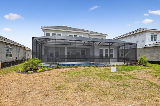 34084 Torrent Ln, Wesley Chapel, FL 33543 - rear view of property with a lawn and glass enclosure