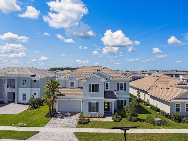 34084 Torrent Ln, Wesley Chapel, FL 33543 - view of front facade with a residential view, decorative driveway, stucco siding, a front lawn, and an attached garage