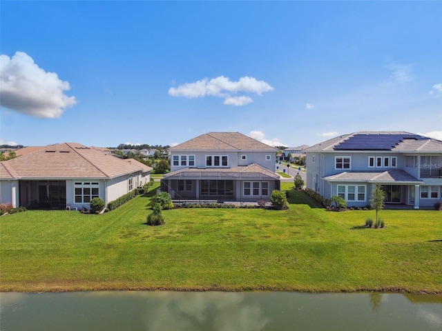 34084 Torrent Ln, Wesley Chapel, FL 33543 - rear view of property featuring a water view, a residential view, and a lawn