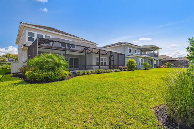 34084 Torrent Ln, Wesley Chapel, FL 33543 - back of property with a lawn and glass enclosure