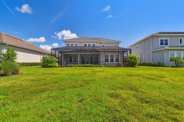 34084 Torrent Ln, Wesley Chapel, FL 33543 - rear view of house featuring a yard and glass enclosure