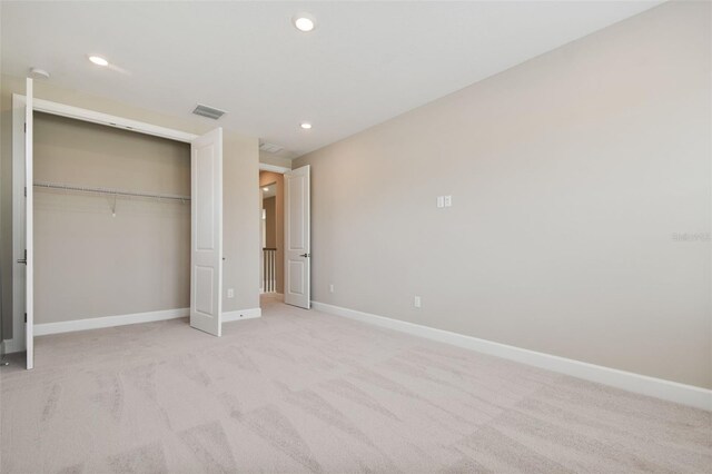 34084 Torrent Ln, Wesley Chapel, FL 33543 - unfurnished bedroom featuring a closet, recessed lighting, and light carpet