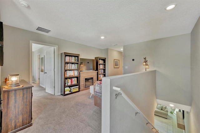hallway with carpet, recessed lighting, baseboards, an upstairs landing, and visible vents