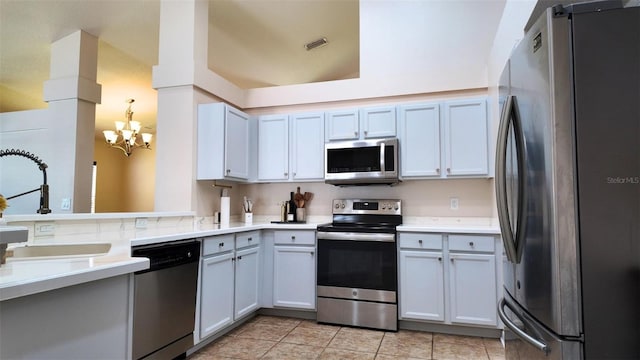13653 Artesa Bell Dr, Riverview, FL 33579 - kitchen featuring appliances with stainless steel finishes, a sink, a chandelier, light countertops, and light tile patterned floors