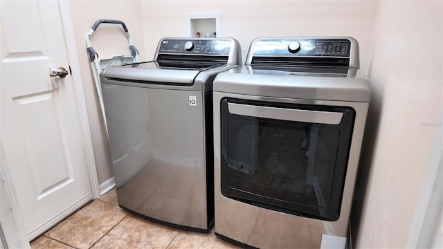 13653 Artesa Bell Dr, Riverview, FL 33579 - washroom with washing machine and clothes dryer and light tile patterned flooring