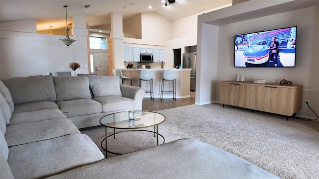 13653 Artesa Bell Dr, Riverview, FL 33579 - living area with light colored carpet, baseboards, and high vaulted ceiling