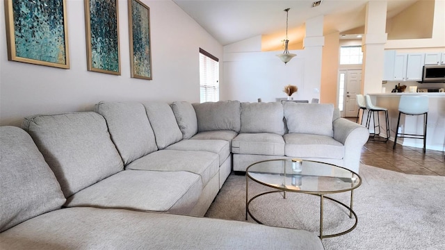 13653 Artesa Bell Dr, Riverview, FL 33579 - living area with vaulted ceiling, dark tile patterned floors, and dark colored carpet
