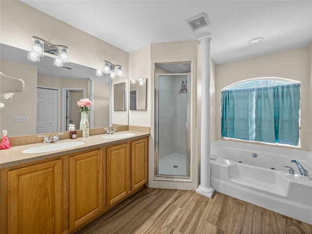 bathroom with visible vents, a whirlpool tub, a shower stall, and a sink