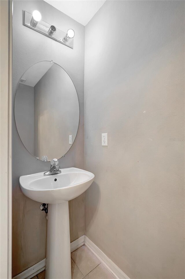 bathroom with tile patterned floors and baseboards