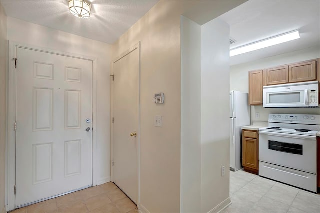 kitchen featuring white appliances and light countertops