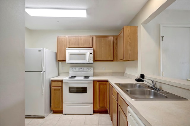 kitchen featuring white appliances, a sink, light tile patterned flooring, and light countertops