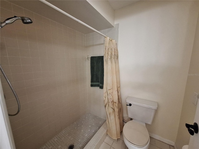 full bathroom with a shower stall, toilet, and tile patterned flooring
