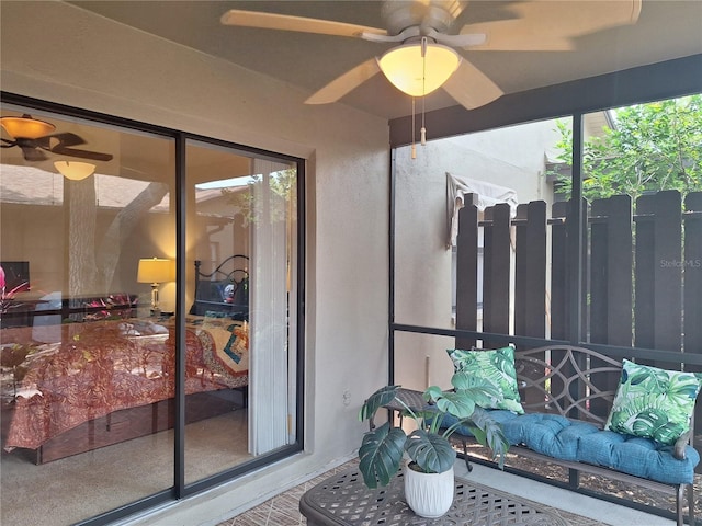 sunroom / solarium with a ceiling fan