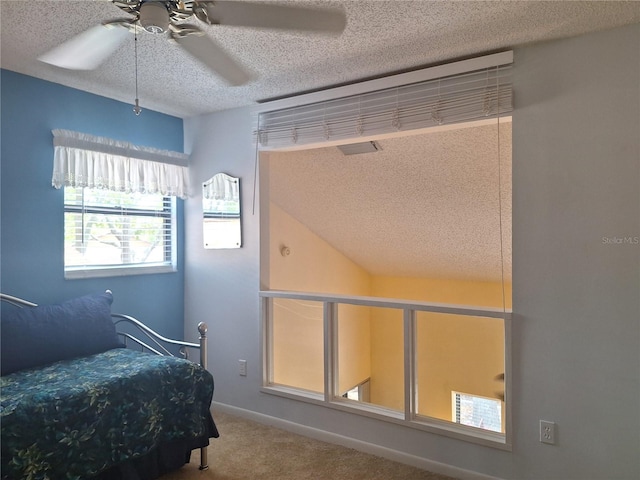 bedroom featuring a textured ceiling, carpet, ceiling fan, and baseboards