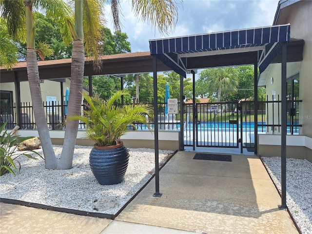 view of property's community featuring fence and a swimming pool