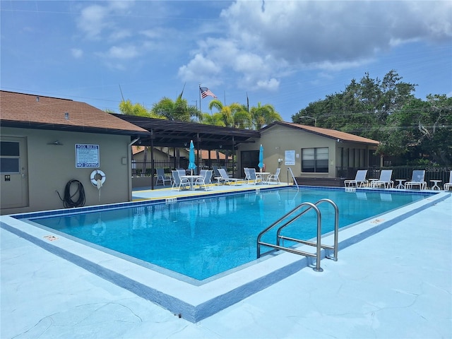 community pool featuring fence and a patio