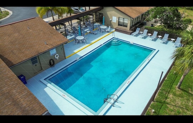 community pool featuring a patio area and fence
