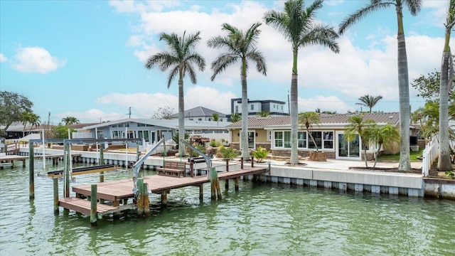 dock area with a water view and boat lift