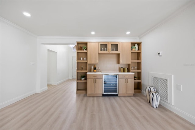bar featuring visible vents, crown molding, wine cooler, bar area, and light wood-style flooring
