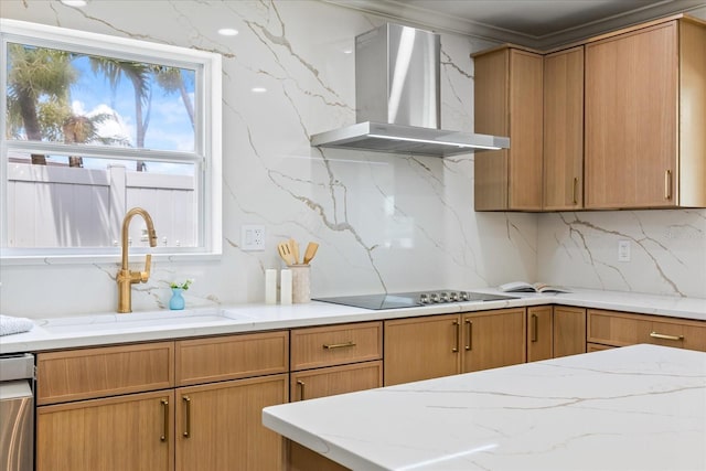 kitchen featuring wall chimney range hood, tasteful backsplash, a sink, light stone counters, and black electric stovetop