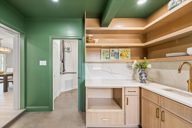 interior space with a sink, visible vents, concrete flooring, baseboards, and recessed lighting